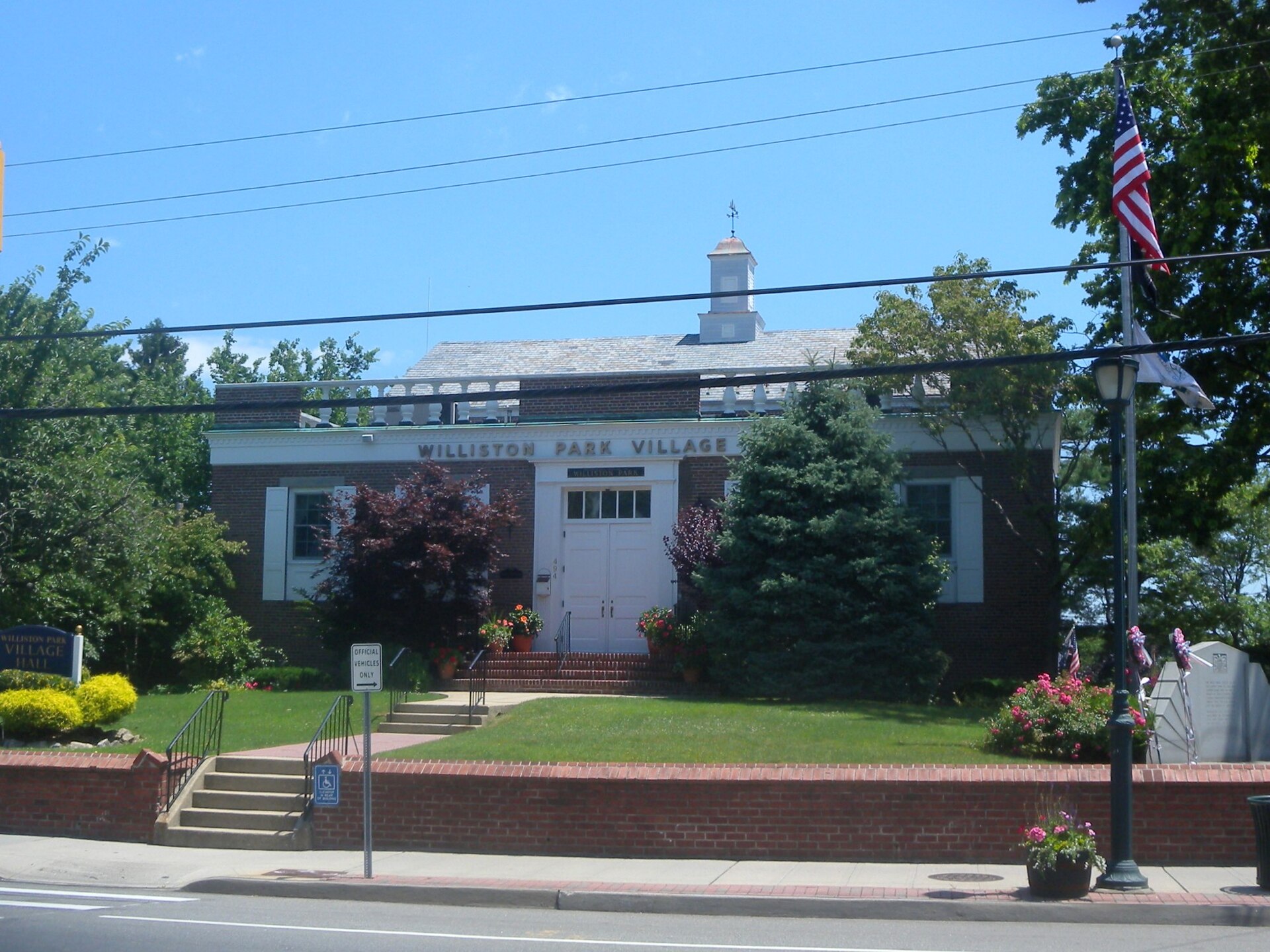 Looking east across Willis Avenue at Village Hall, on a sunny midday. — Williston Park, New York
