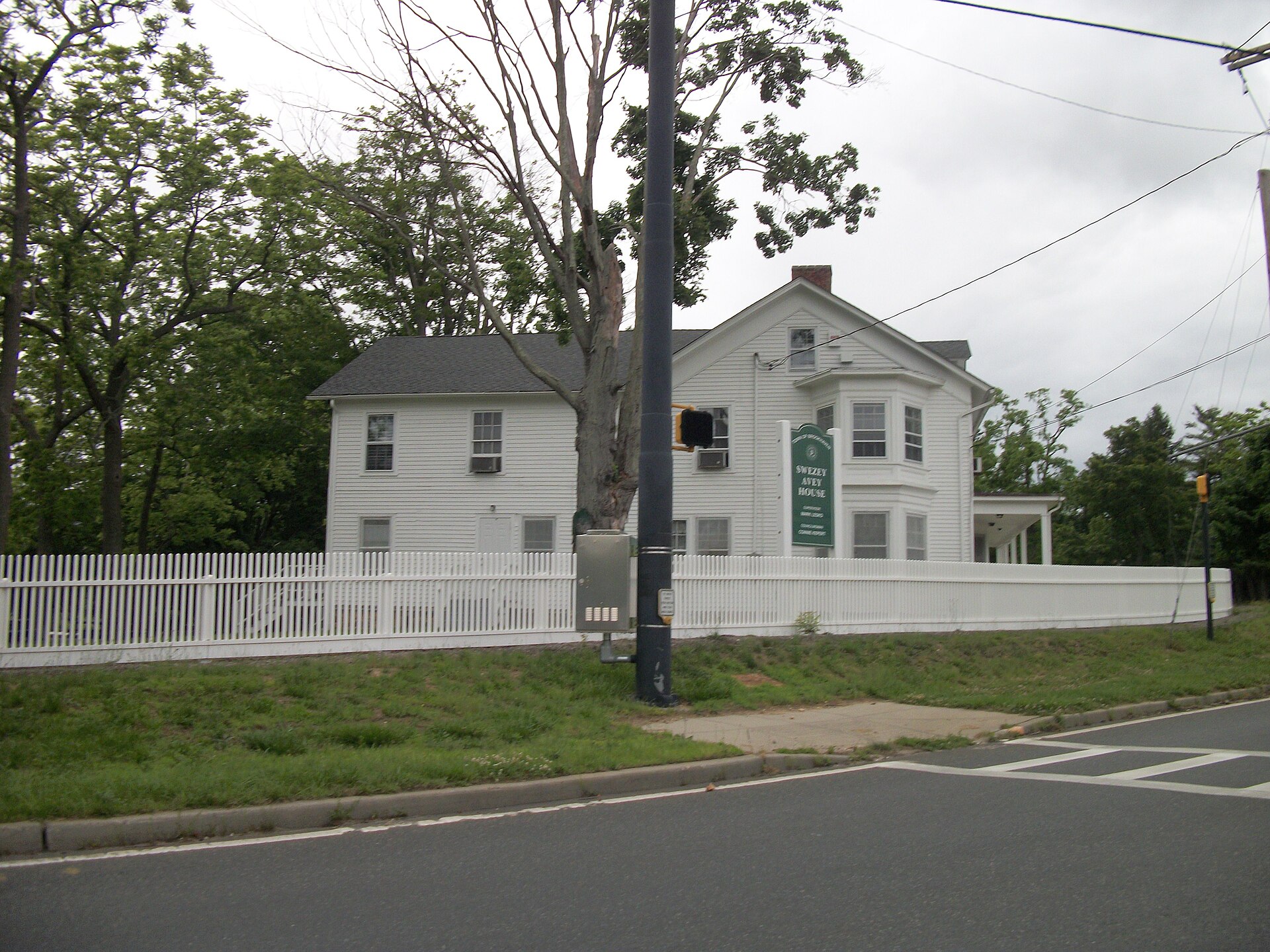 The historic Swezey-Avey House on the corner of Main Street and Mill Road and Town of Brookhaven's Yaphank Beach in Yaphank, New York.