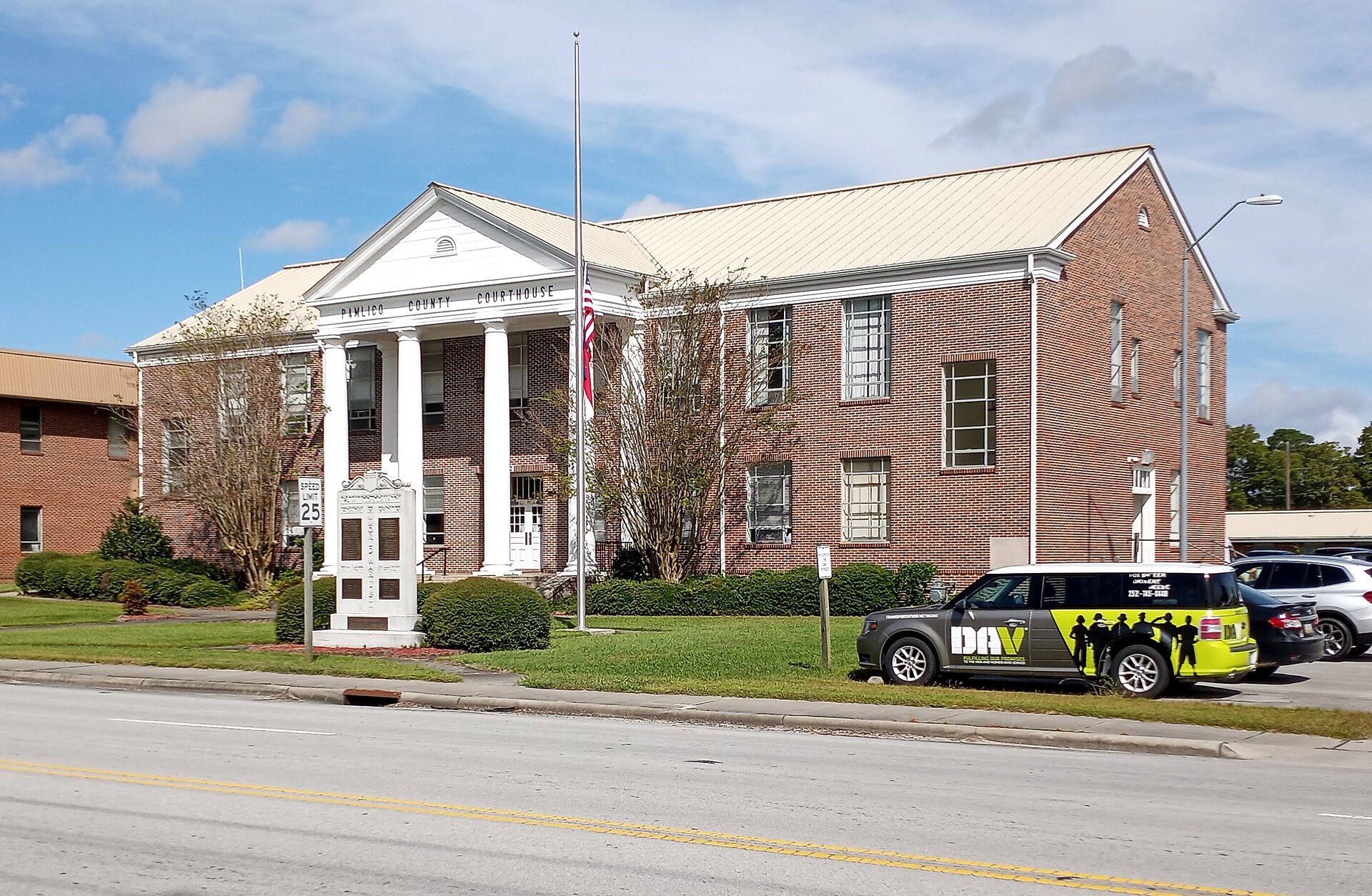 Pamlico County Courthouse in North Carolina. Flag is at half-staff in commemoration of National Fallen Firefighters Memorial Day. — Bayboro, North Carolina