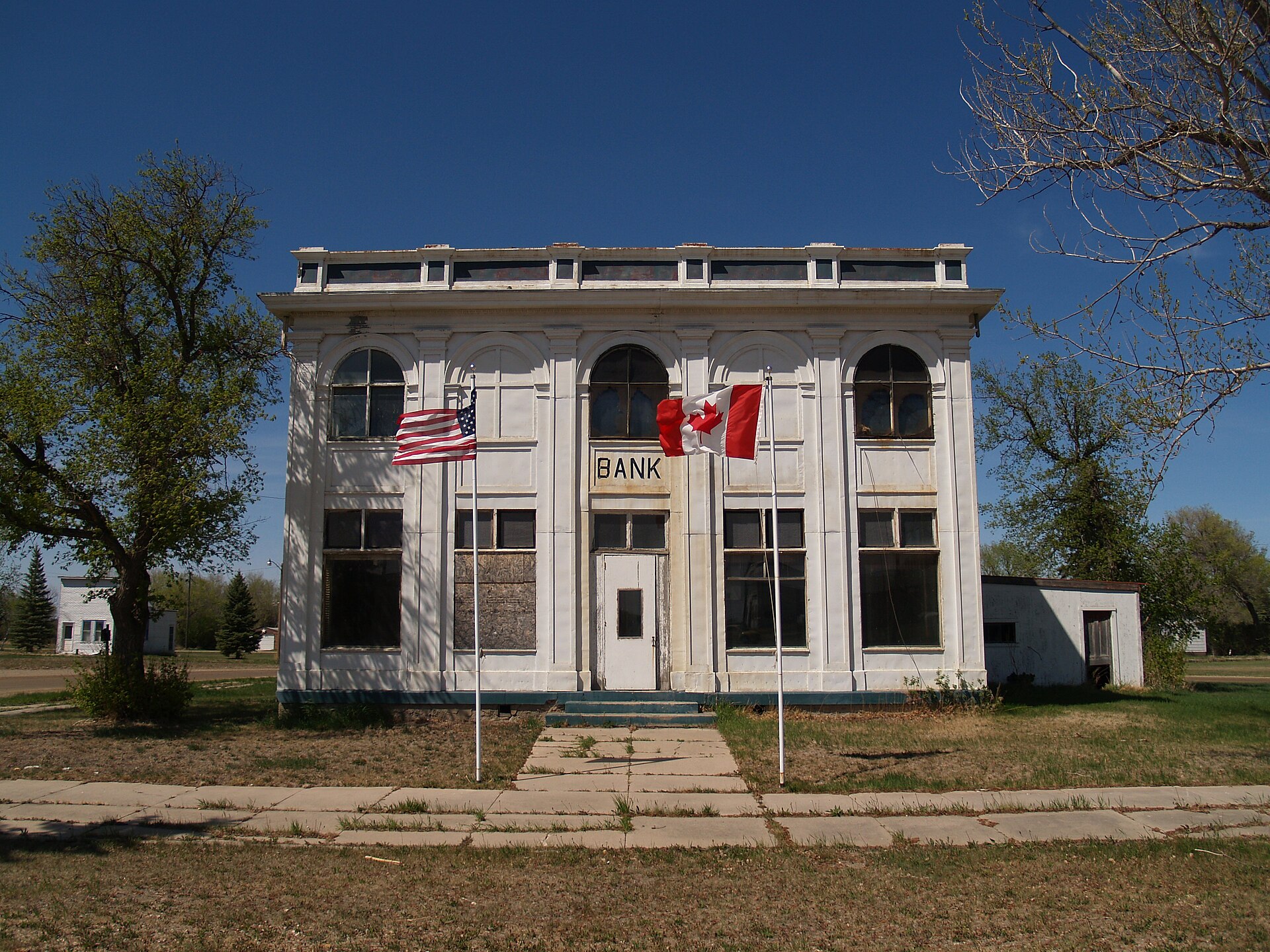 2nd view of the customs house in Antler, North Dakota showing U.S. and Canadian flags. — Bottineau County, North Dakota