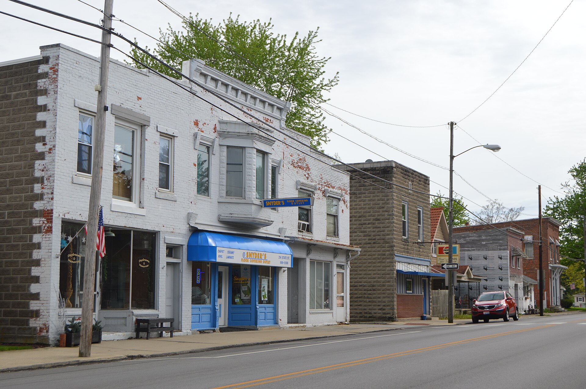 Buildings on the southeastern side of the 200 block of State Street (State Route 12) in the commercial district of Bettsville, Ohio, United States.