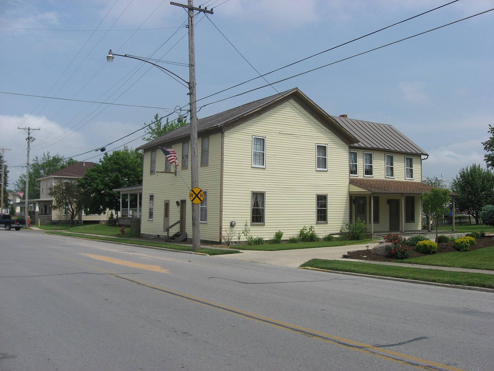 Front and northern side of the Shelby House, located at 403 W. State Street in Botkins, Ohio, United States. A former coach house built in 1864, it is listed on the National Register of Historic Places.