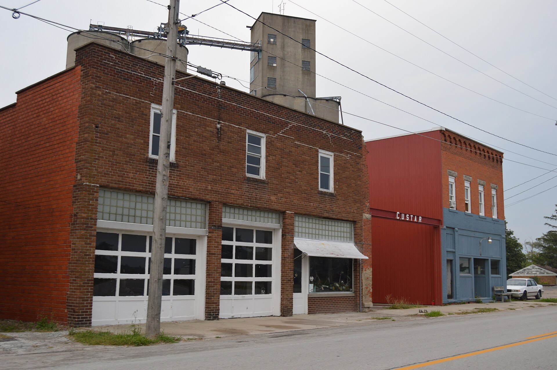 Buildings on Defiance Pike (State Route 281) just east of the Superior Street intersection in Custar, Ohio, United States. The community grain elevator is visible in the background.