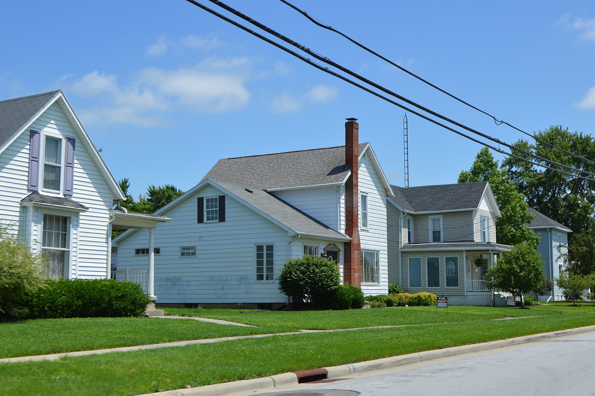 Houses on the northeastern side of Main Street, northwest of the Baxter Street intersection, in Elida, Ohio, United States.