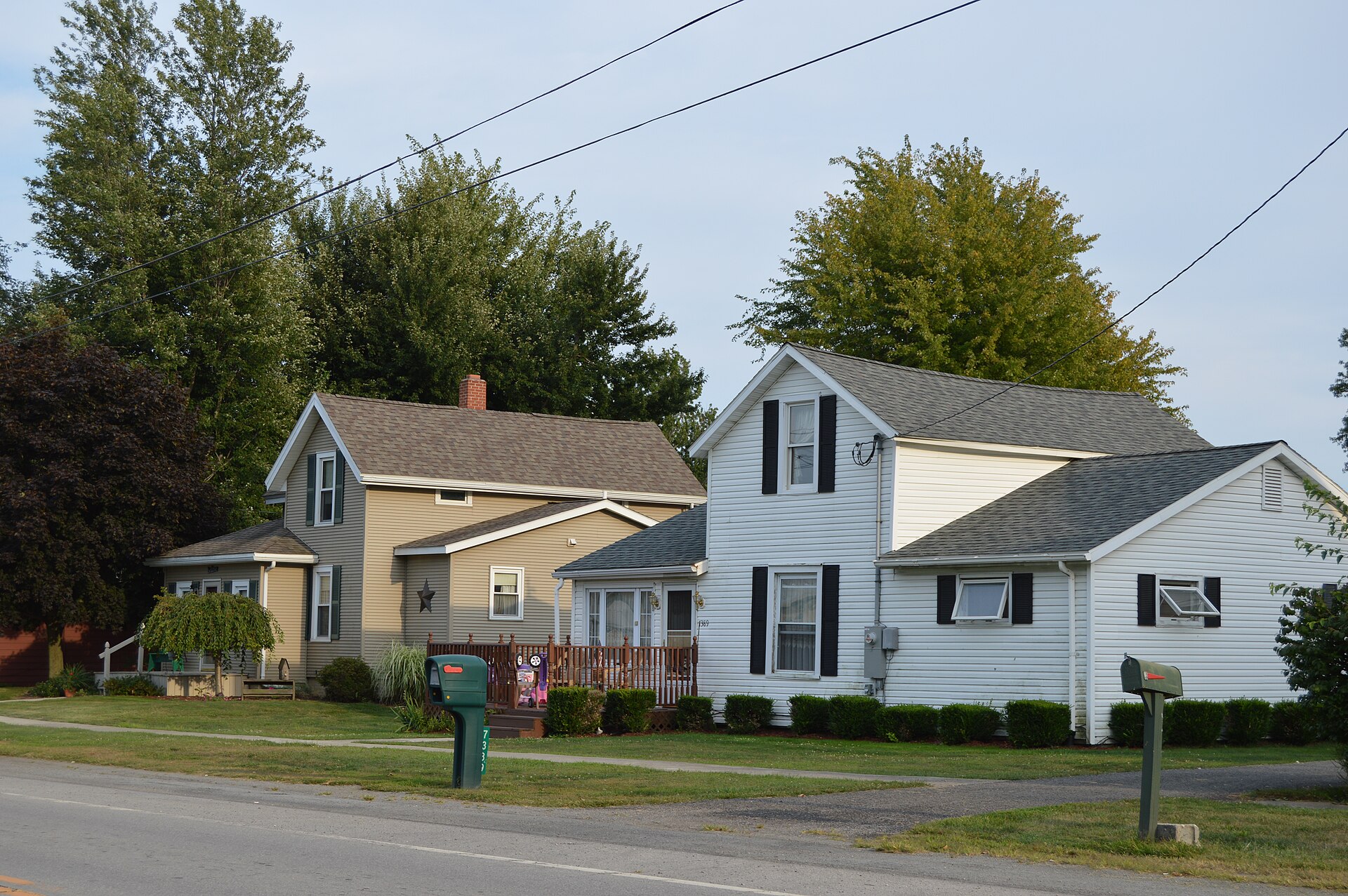 Houses on the southern side of Main Street (State Route 294) just west of the Oneida Street intersection in Harpster, Ohio, United States.
