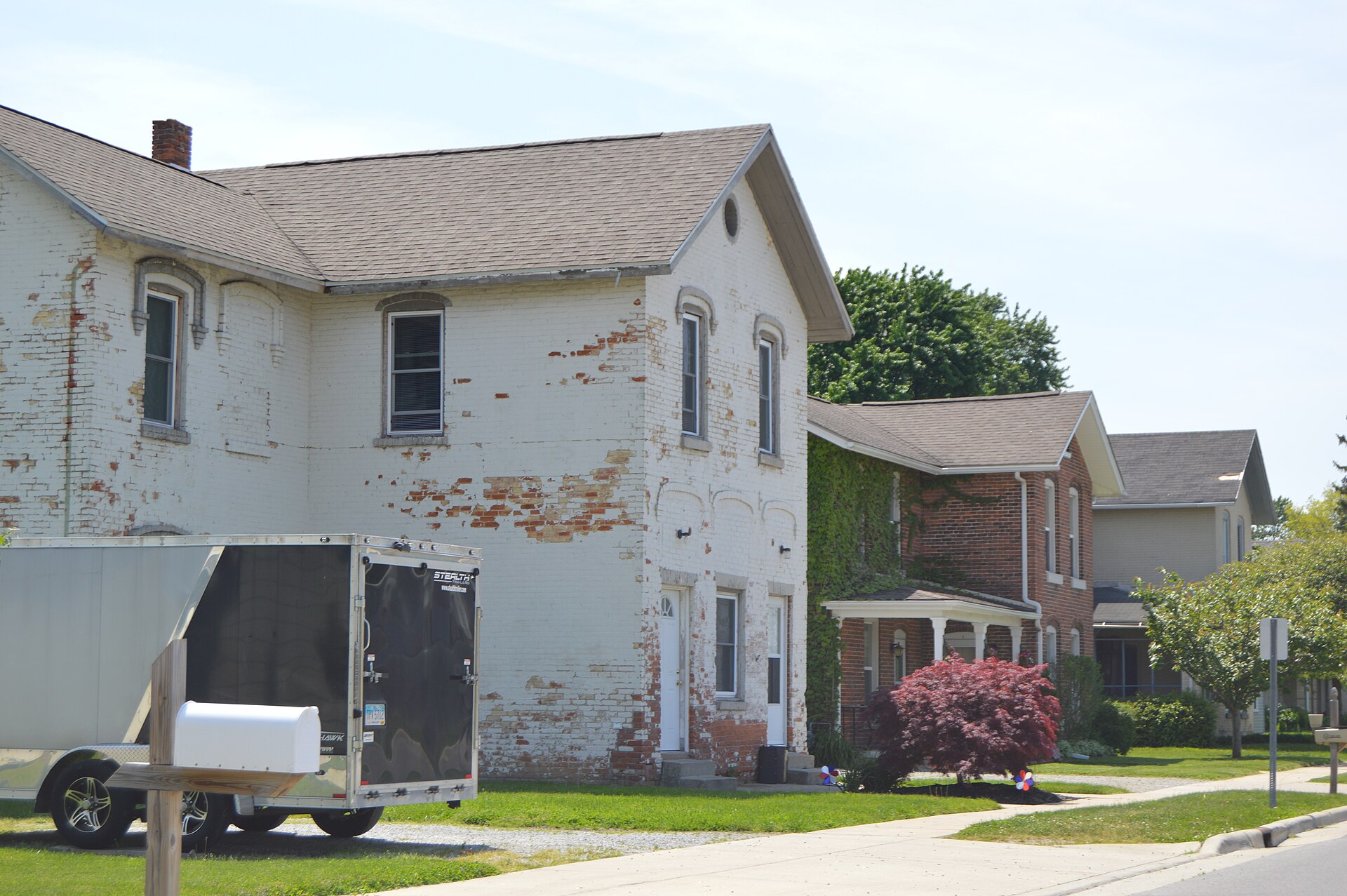 Houses on the southern side of Railroad Street, immediately west of the Maumee Street intersection, in Holland, Ohio, United States.