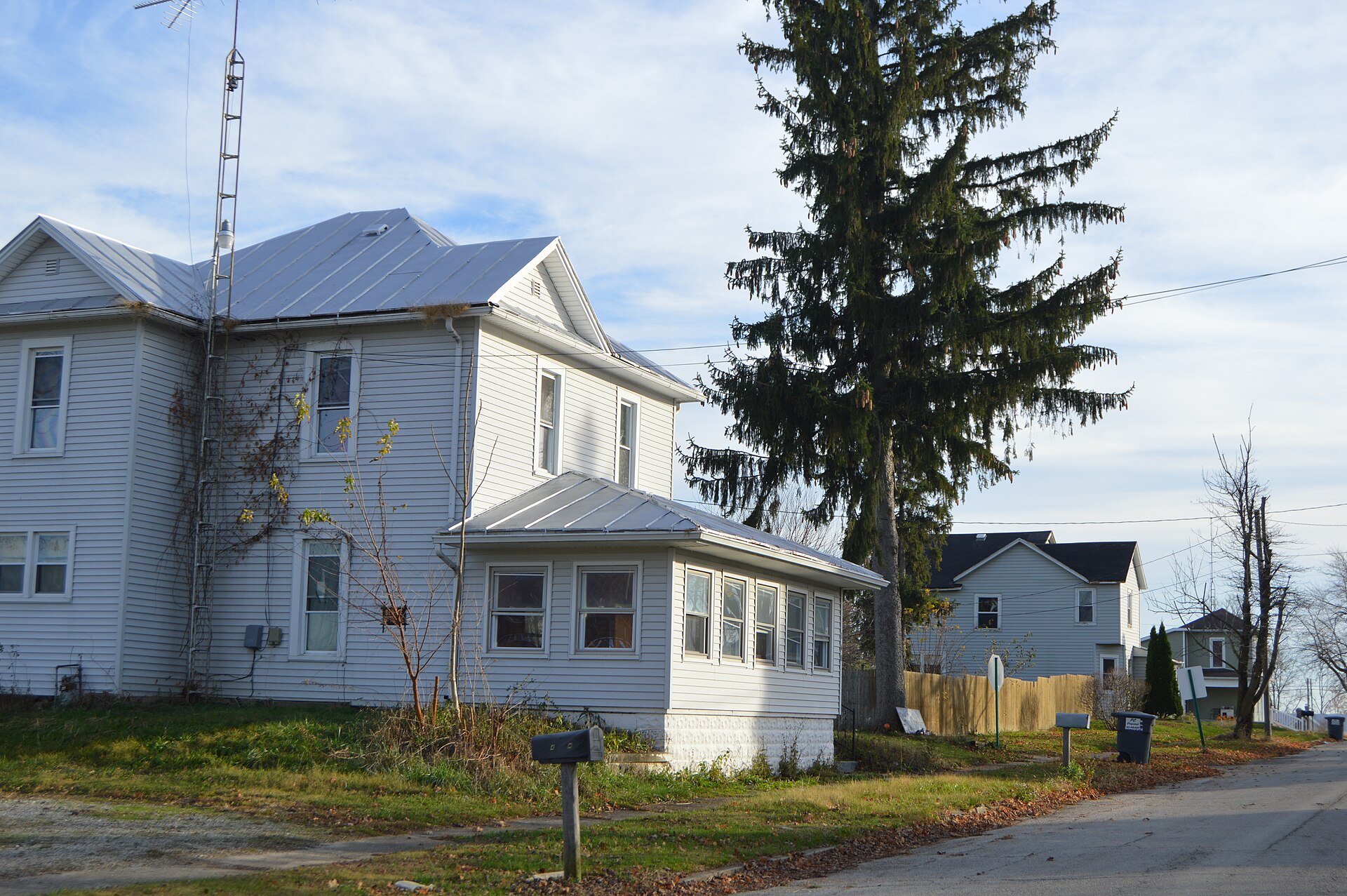 Houses on the eastern side of Elm Street at the Pease Street intersection in Hollansburg, Ohio, United States.