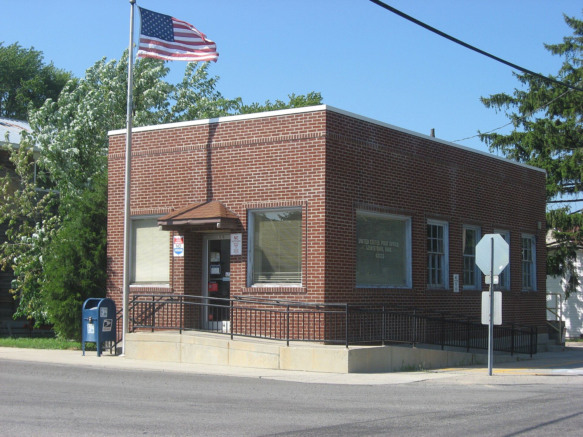 The post office and principal intersection in Lewistown, an unincorporated community in Washington Township, Logan County, Ohio, United States. Built in 1910, it was a bank until 1932.