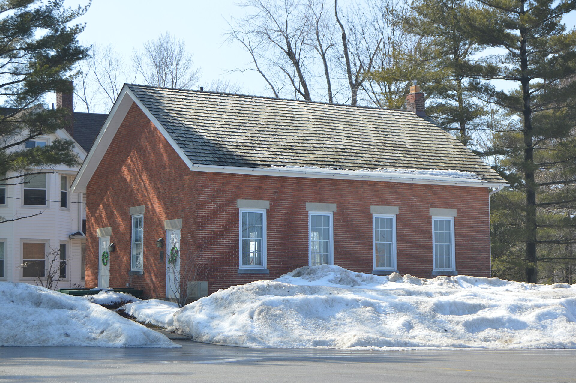 Northern side and front of the Old Euclid District 4 Schoolhouse, located on the western side of Richmond Road (State Route 175) at the Oakmont Drive intersection in Lyndhurst, Ohio, United States.