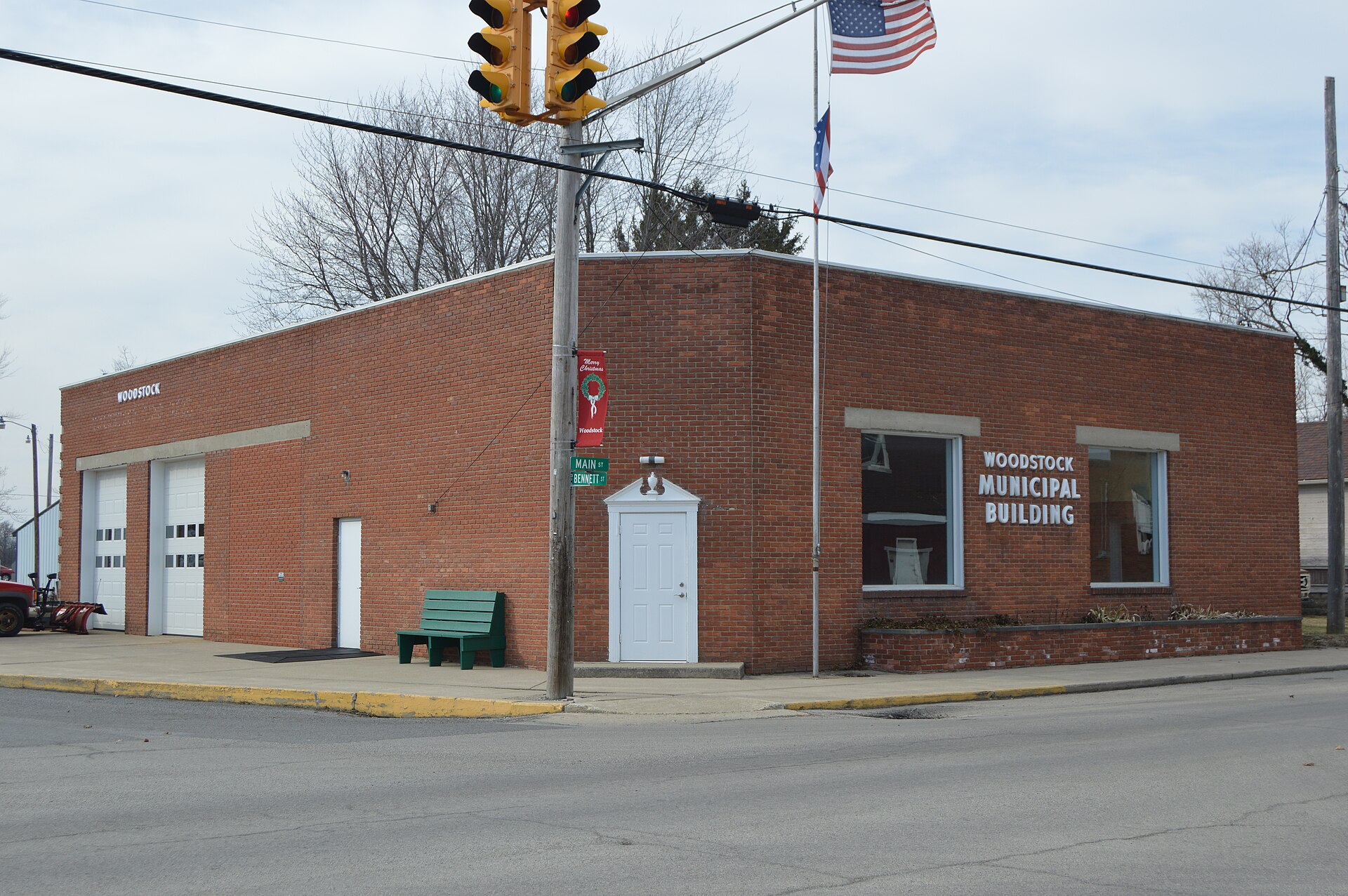 Front and southern side of the Woodstock village hall and fire station, located on the northwestern corner of the junction of Main (State Route 559) and Bennett Streets in Woodstock, Ohio, United States.