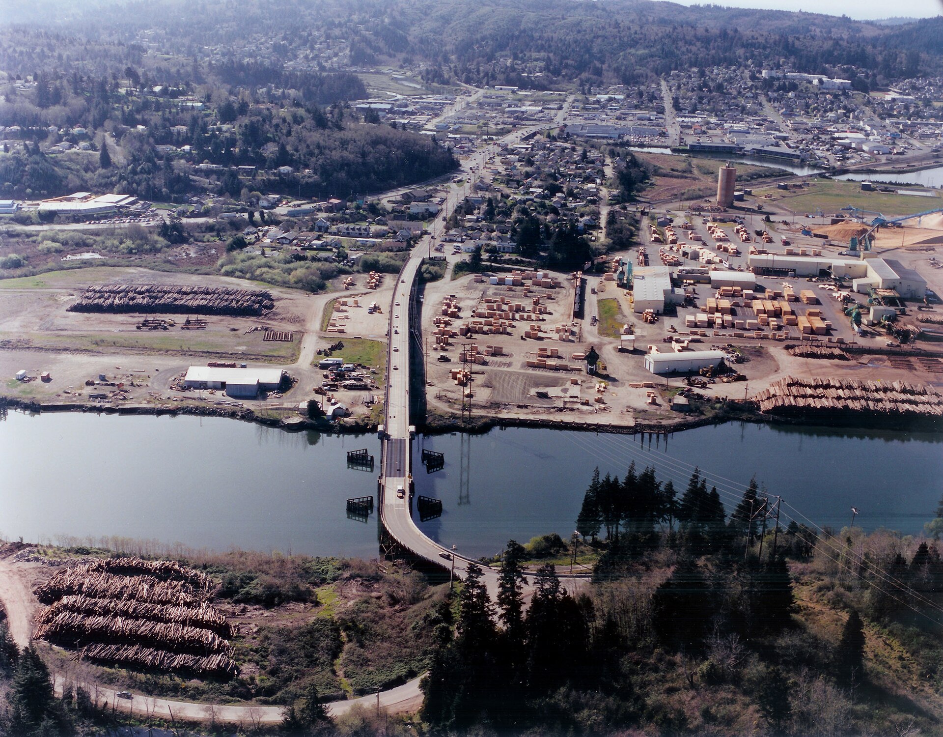 The Isthmus Slough Bridge can be seen in the foreground of this 2005 photo. — Coos Bay, Oregon