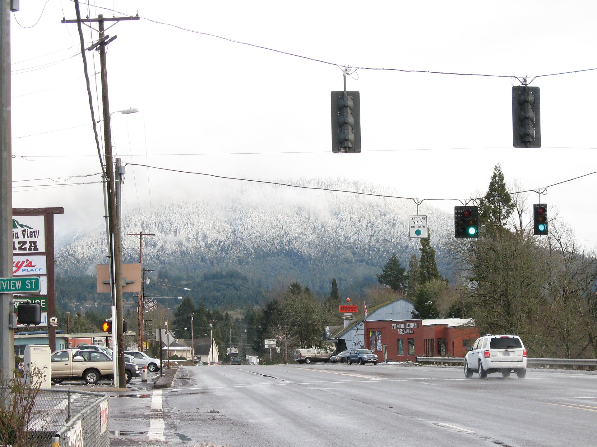 Highway 58 in Oakridge, Oregon, a city in Lane County, with snowy Cascade Range foothills in the background