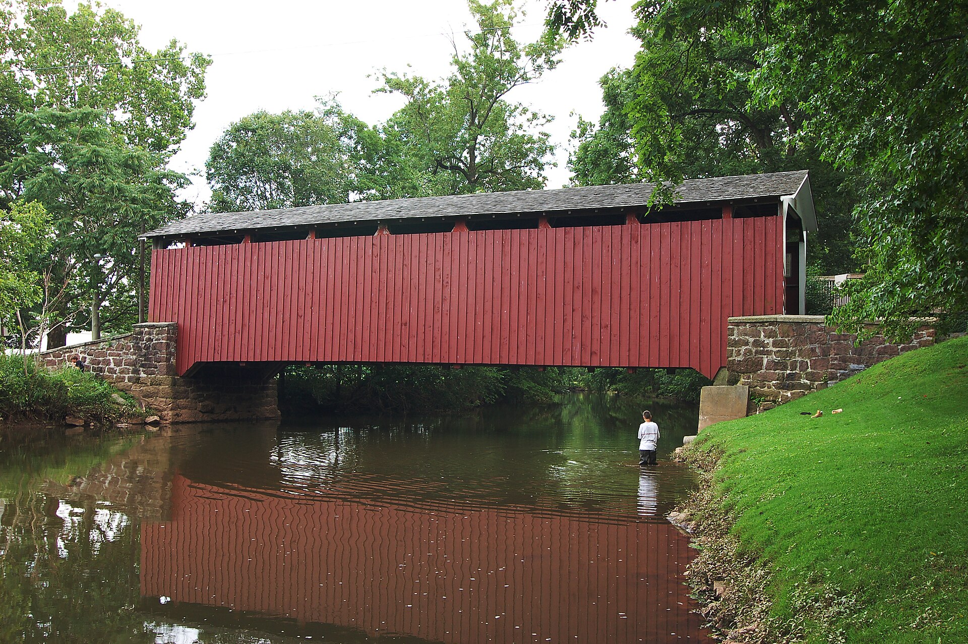 A photograph of full side of the Bucher's Mill Covered Bridge. — Denver, Pennsylvania