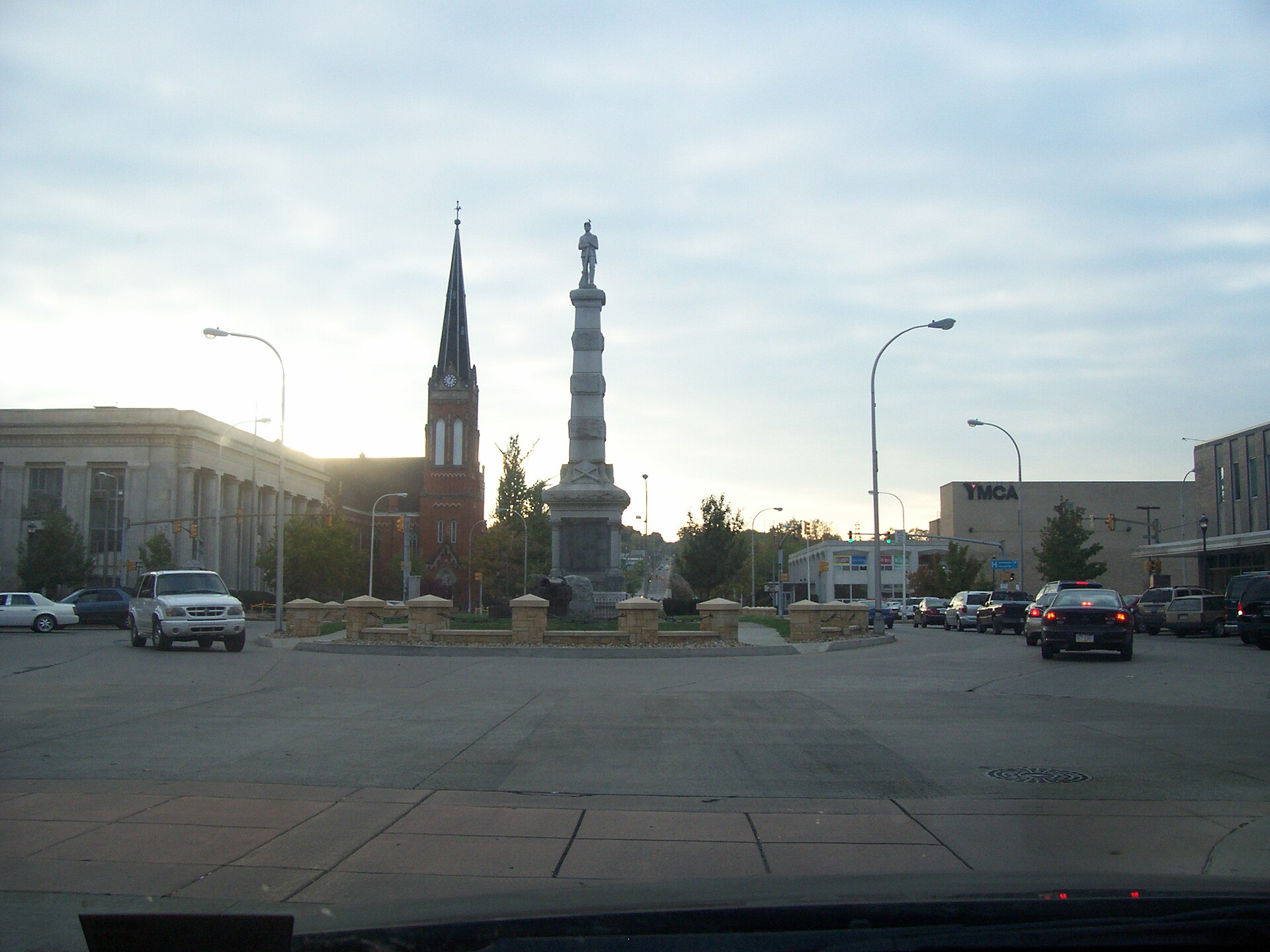 Kennedy Square in downtown New Castle, Pennsylvania, United States. Church tower to the left of the monument is the former First Christian Church, built 1864.