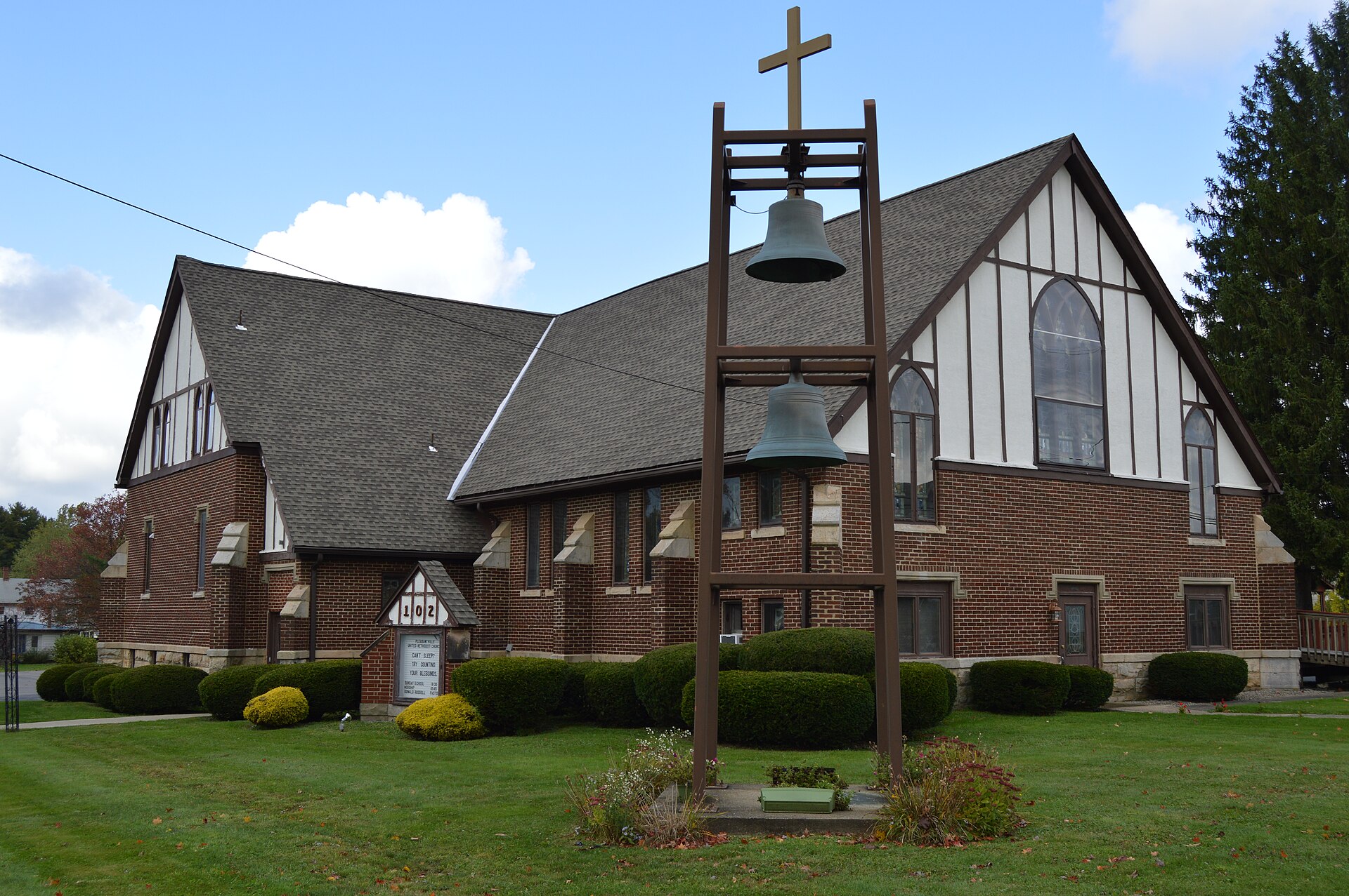 Front and eastern side of the Pleasantville United Methodist Church, located on the northwestern corner of the junction of Main and Merrick Streets in Pleasantville, Pennsylvania, United States.