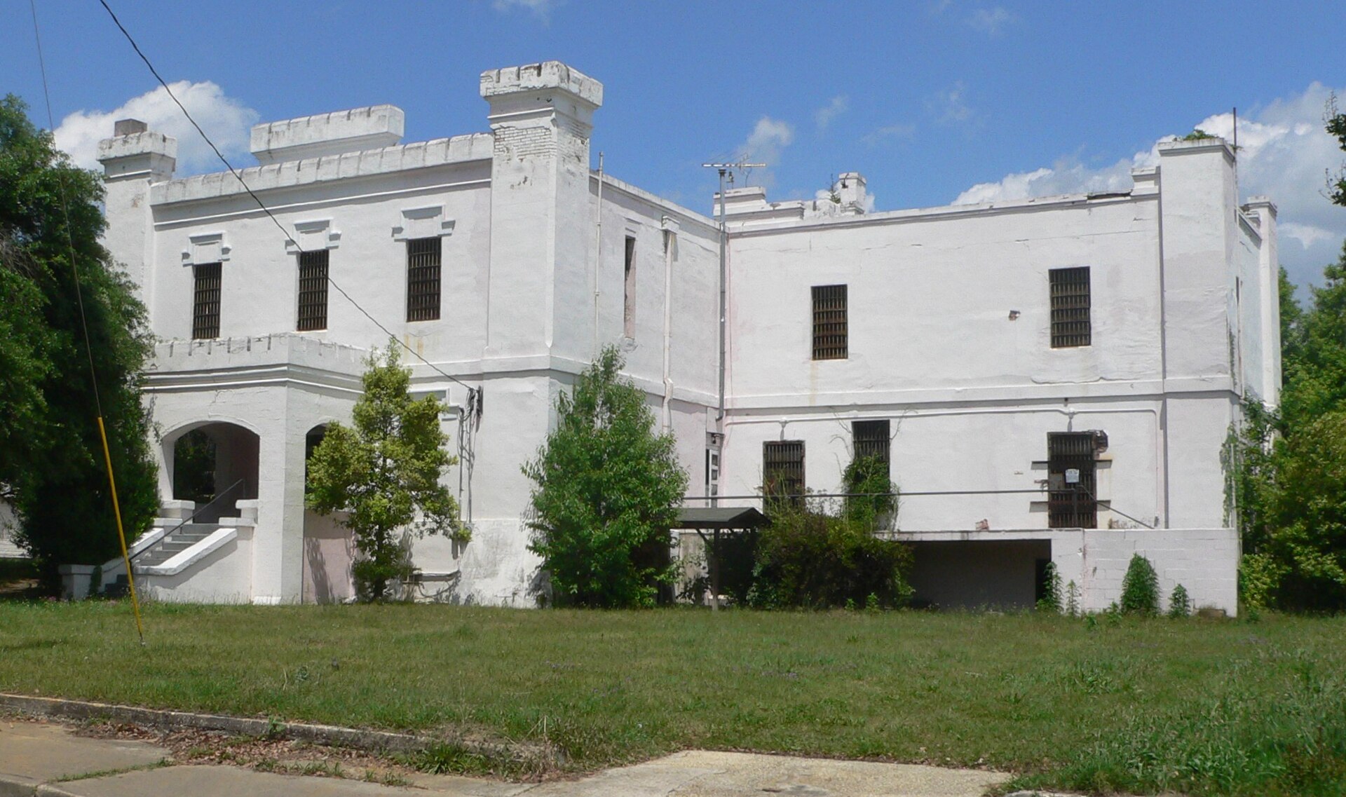 Old Orangeburg County jail at southeast corner of St. John and Meeting Streets in Orangeburg, South Carolina; seen from the southwest, from Meeting.