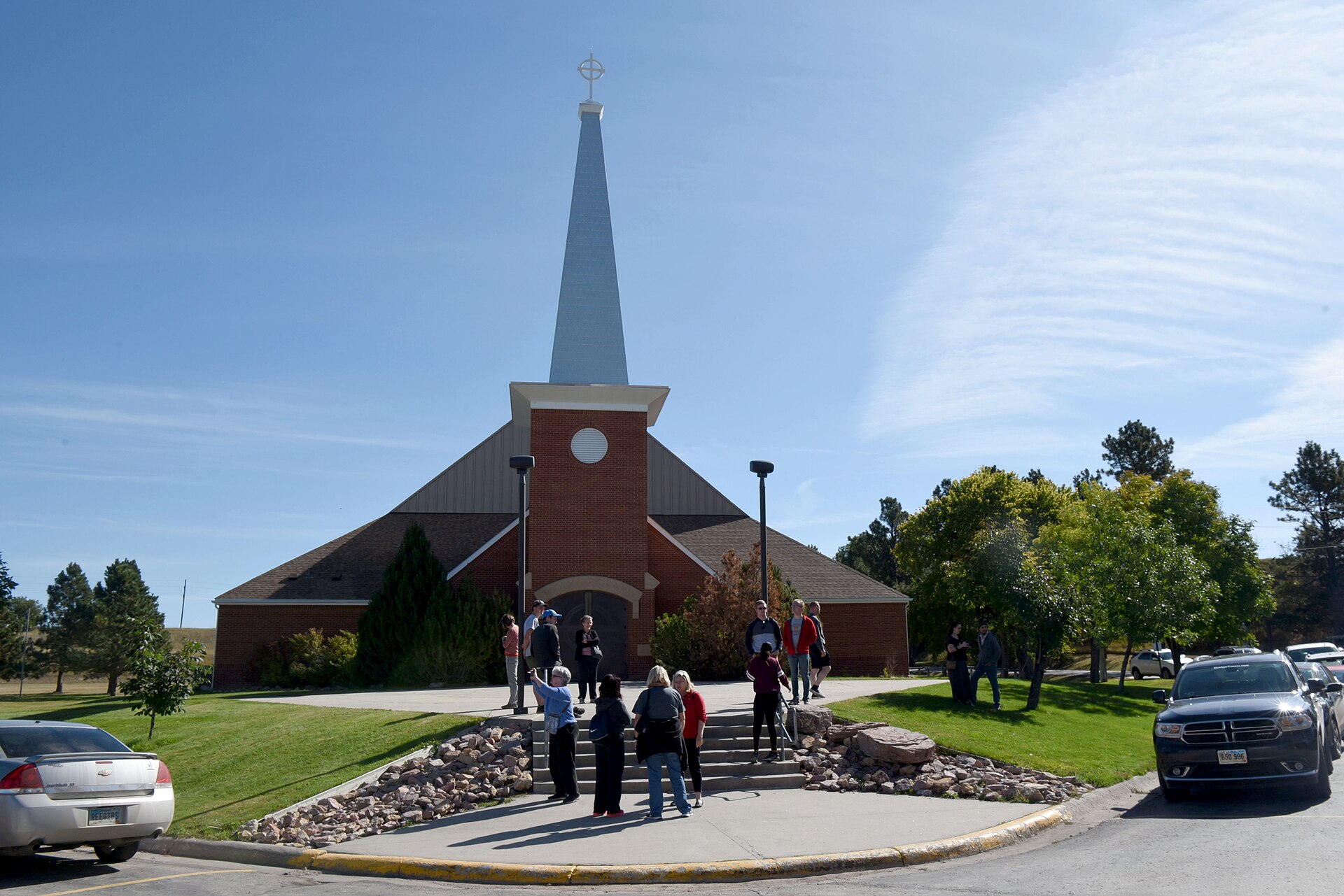 Airmen from the 90th Missile Wing wait outside of the Holy Rosary Catholic Church at Red Cloud Indian School before receiving a tour at the Pine Ridge Reservation, South Dakota., Sept.