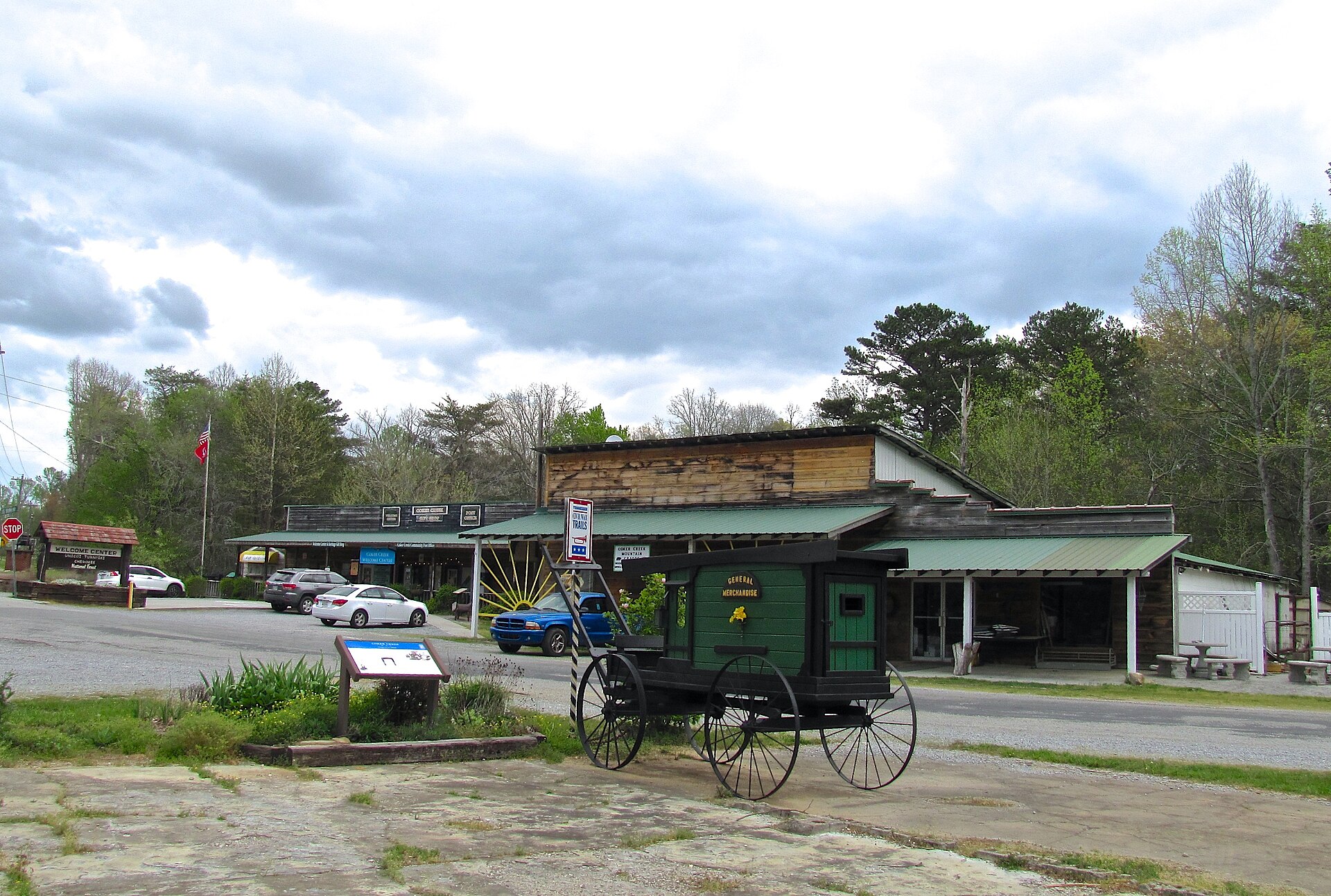 Shops in Coker Creek, Tennessee, United States, with carriage in the foreground. State Route 40 (Unicoi Turnpike) crosses the photo.