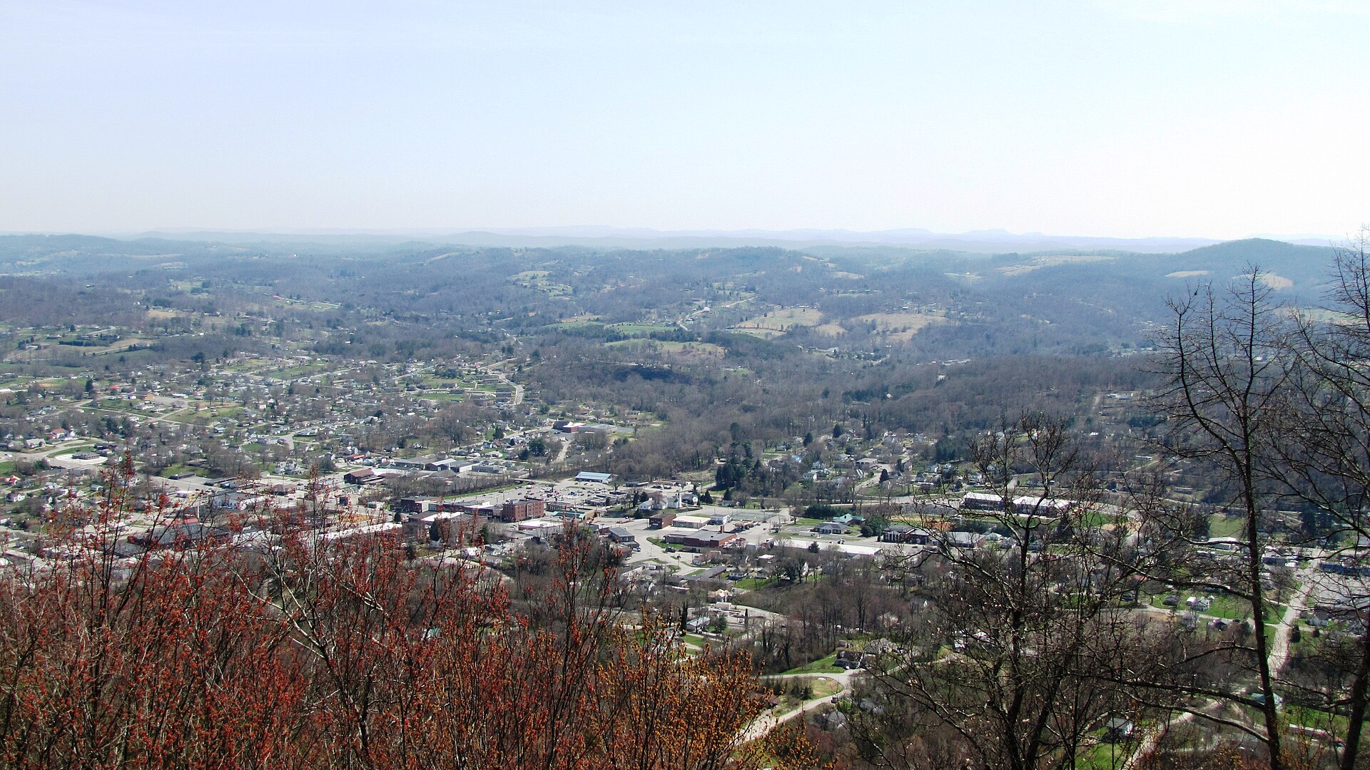 LaFollette, Tennessee, USA, viewed from the Cumberland Trail on the crest of Cumberland Mountain. The buildings at the intersection of Central and Indiana avenues are at the lower left. — La Follette, Tennessee