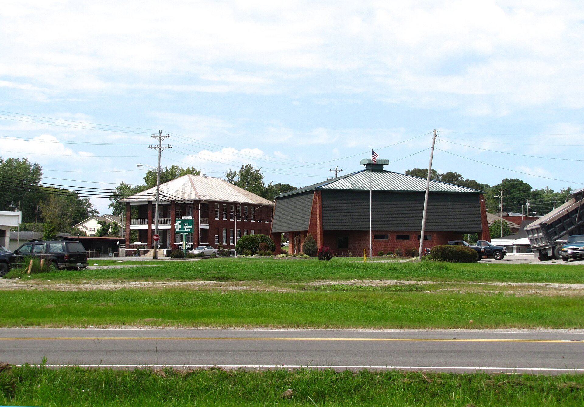 Library (right) and Highland Veterinary Hospital (background, left) in Oneida, Tennessee, United States. Tennessee State Route 456 is in the foreground.