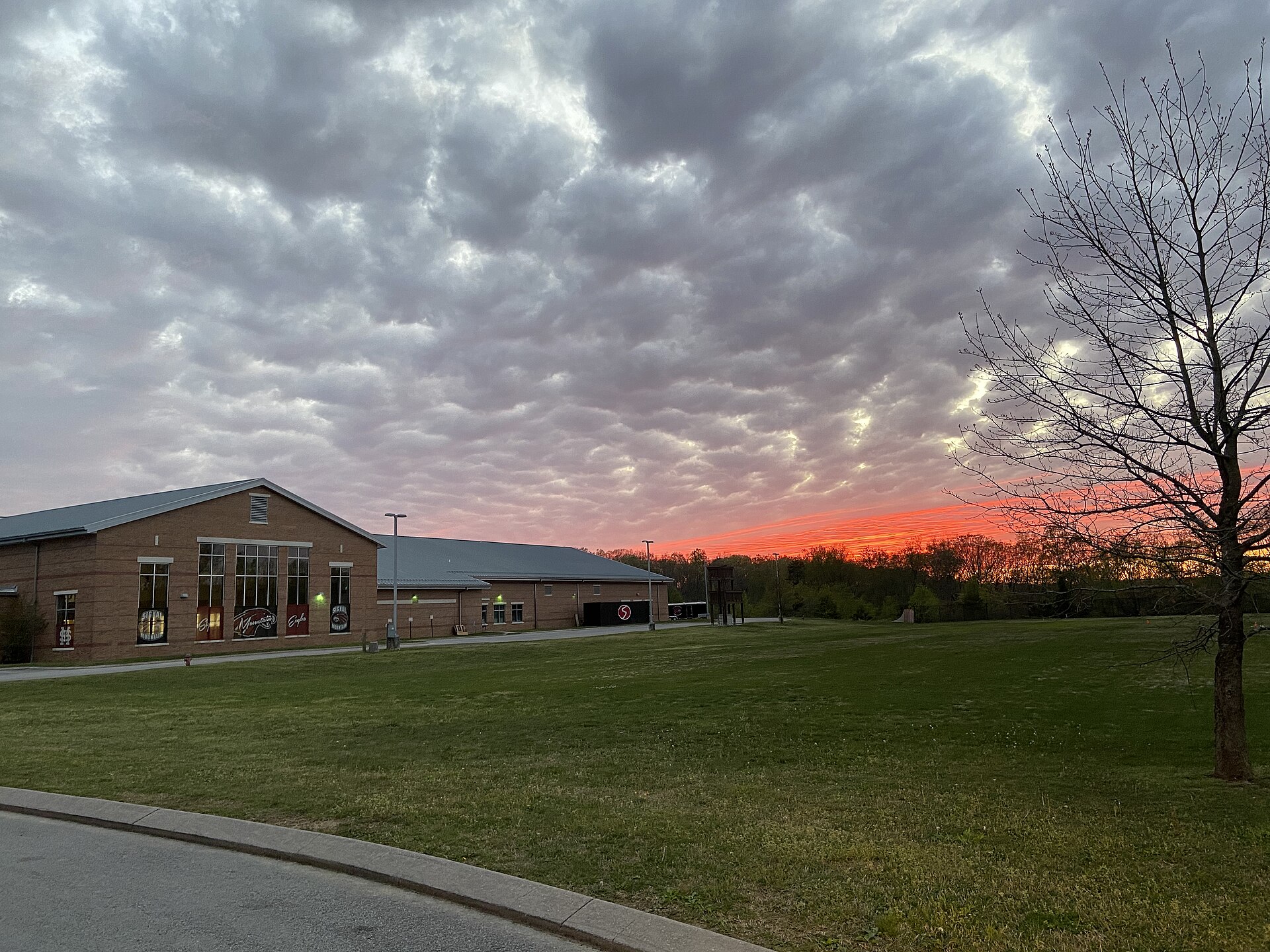 This is a photograph depicting the back of Signal Mountain High School in front of a nice sunset on Signal Mountain, Tennessee