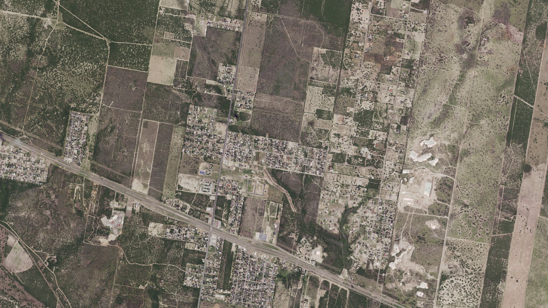 Natural-color aerial photograph of land around Mikes, Texas