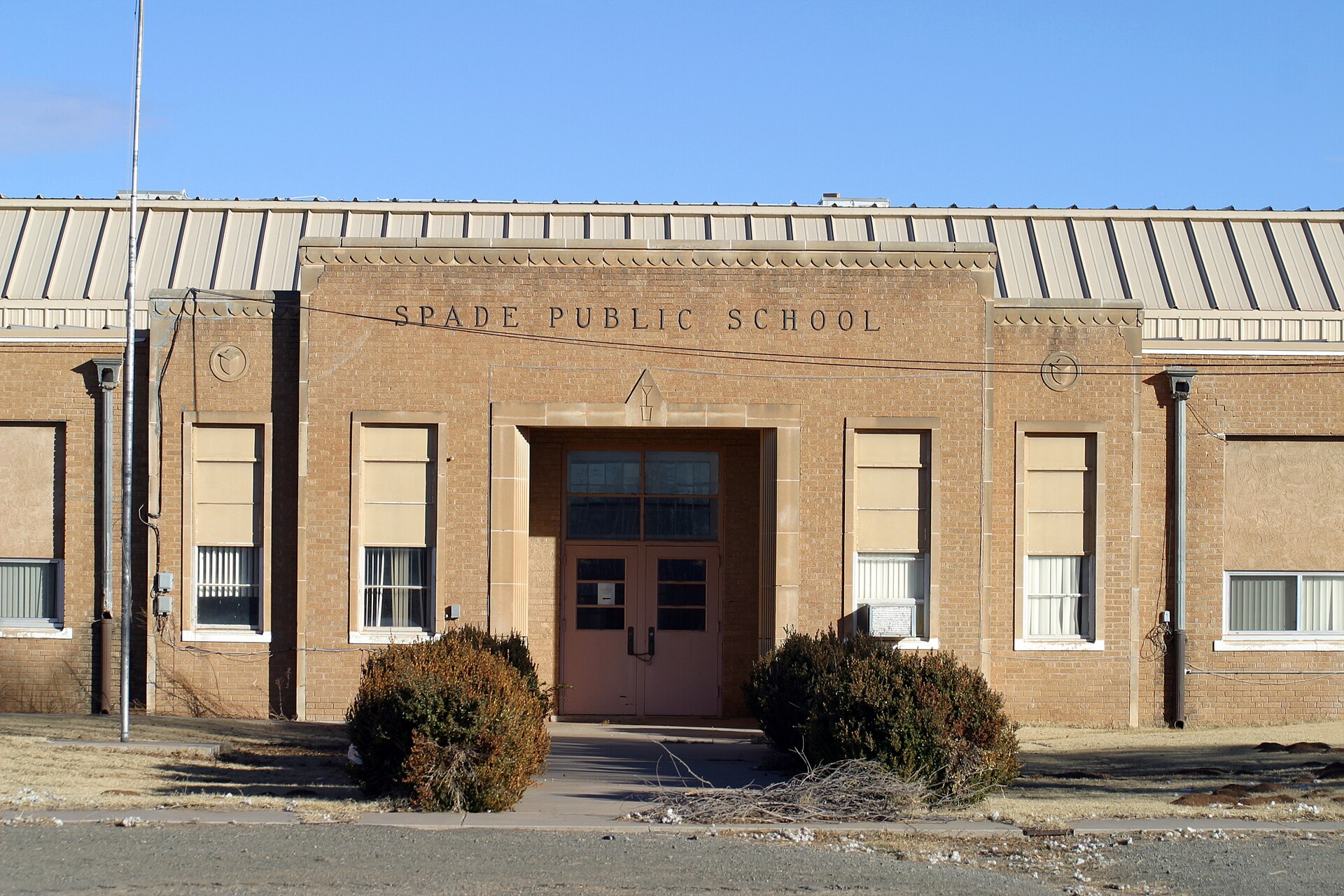 Spade Public School in Spade, Texas in the agricultural region of Lamb County. Note the small spade carved into the stone above the door.