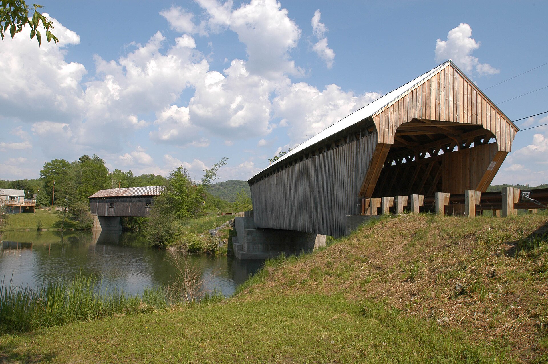 TWO BRIDGES CLOSE TOGETHER OVER OTTAUQUECHEE RIVER IN NORTH HARTLAND. The Willard bridge, on the left, is a 135’ Town lattice truss bridge. — Vermont