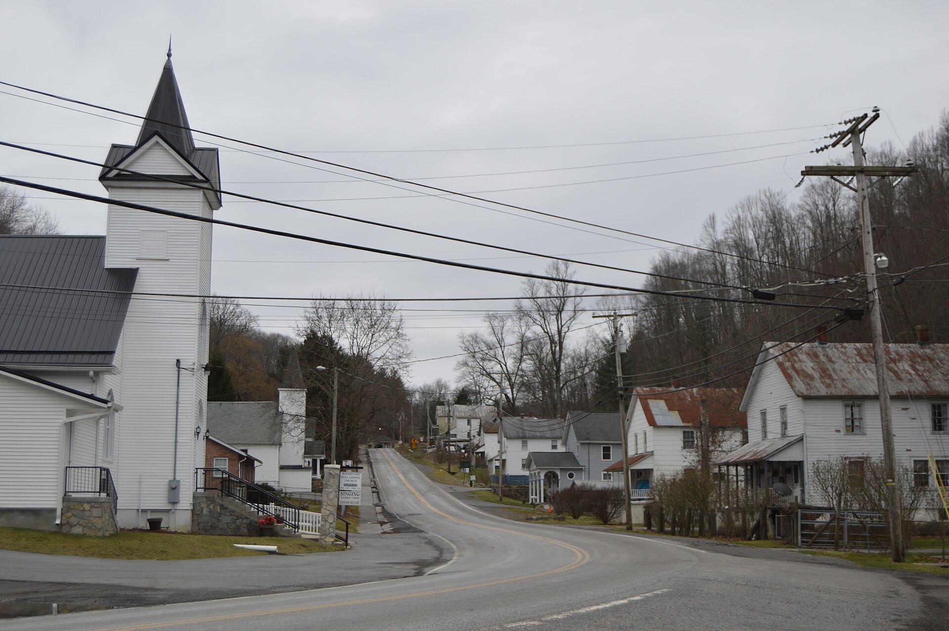 Looking south from the Laurel Creek Road intersection toward houses and a Pentecostal church on Boissevain Road in Boissevain, Virginia, United States.