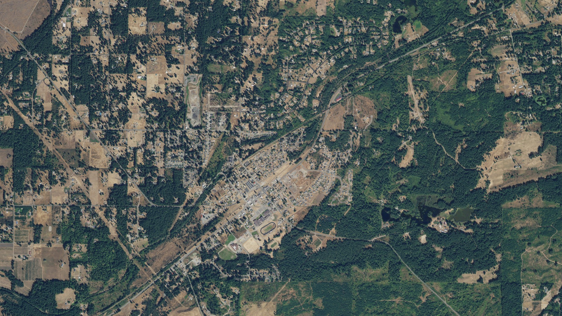 Natural-color aerial photograph of land around Rainier, Washington