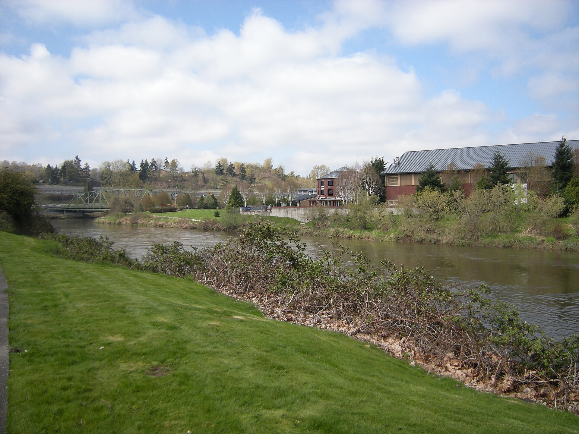 Allentown Bridge (left) and City of Tukwila Community Center, Tukwila, Washington, seen from the Green River Trail along the upper portion of the Duwamish River.