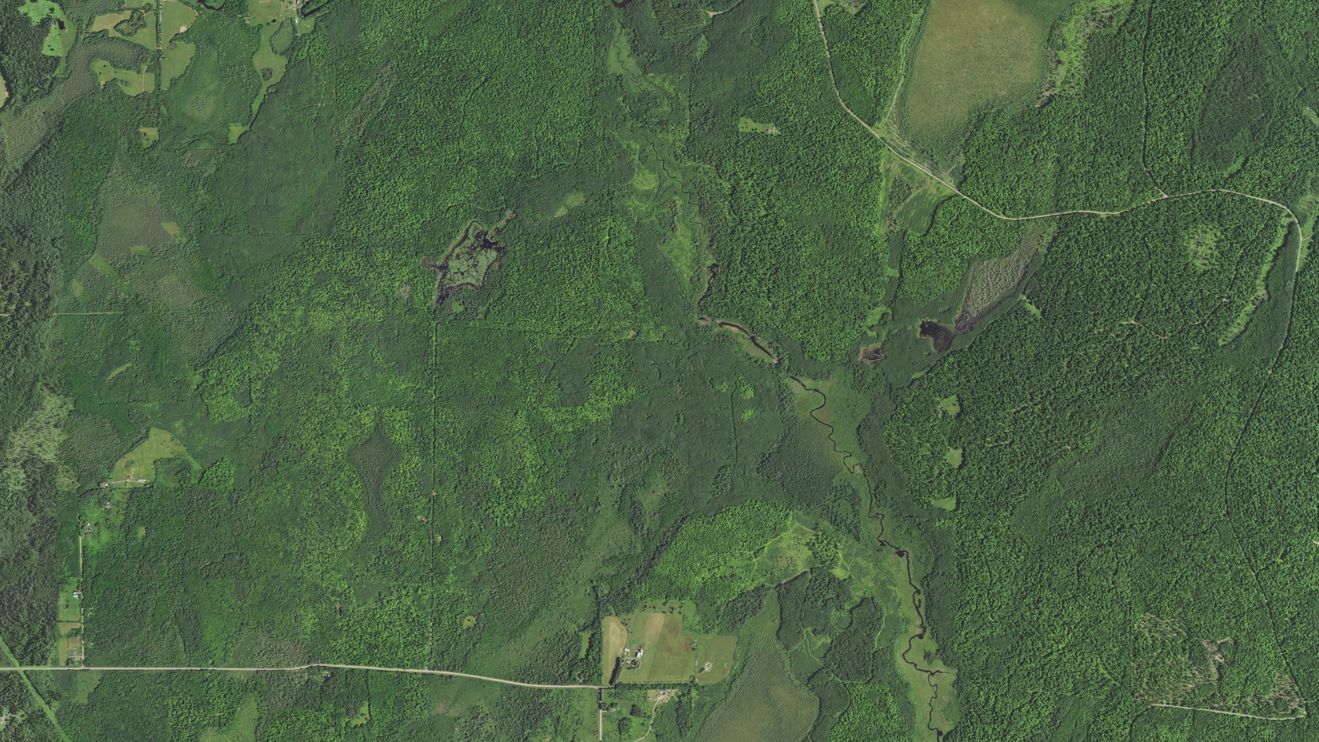 Natural-color aerial photograph of land around Peeksville, Wisconsin