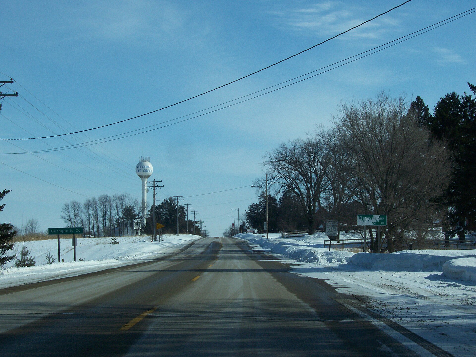 Looking east at the sign for the village of Bear Creek, Outagamie County, Wisconsin - right at the Outagamie County line. Taken while traveling east on Wisconsin Highway 76.