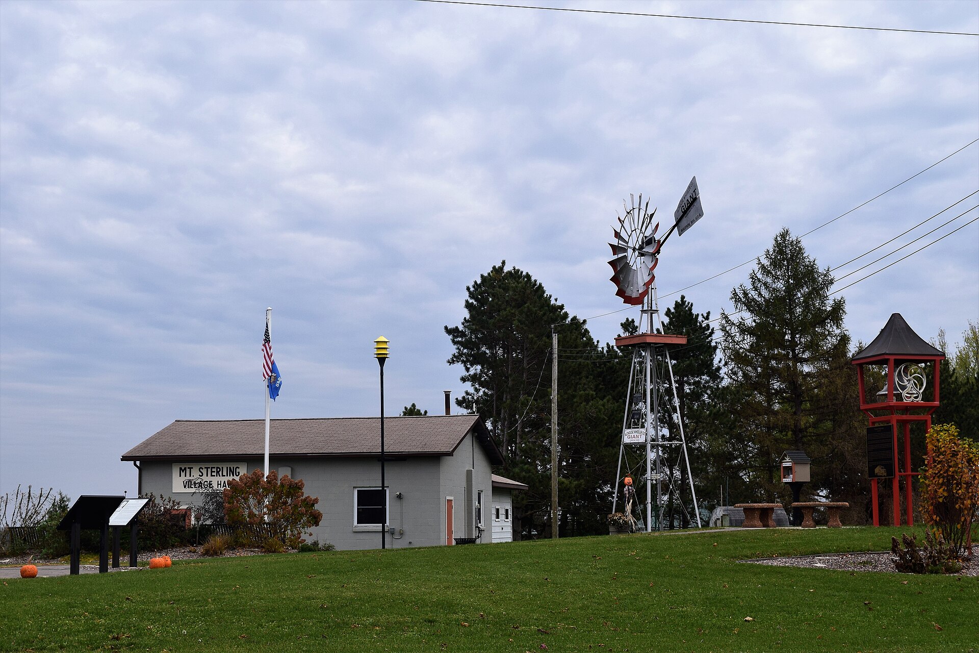 The village hall and a public park with a windmill in Mount Sterling, Wisconsin.