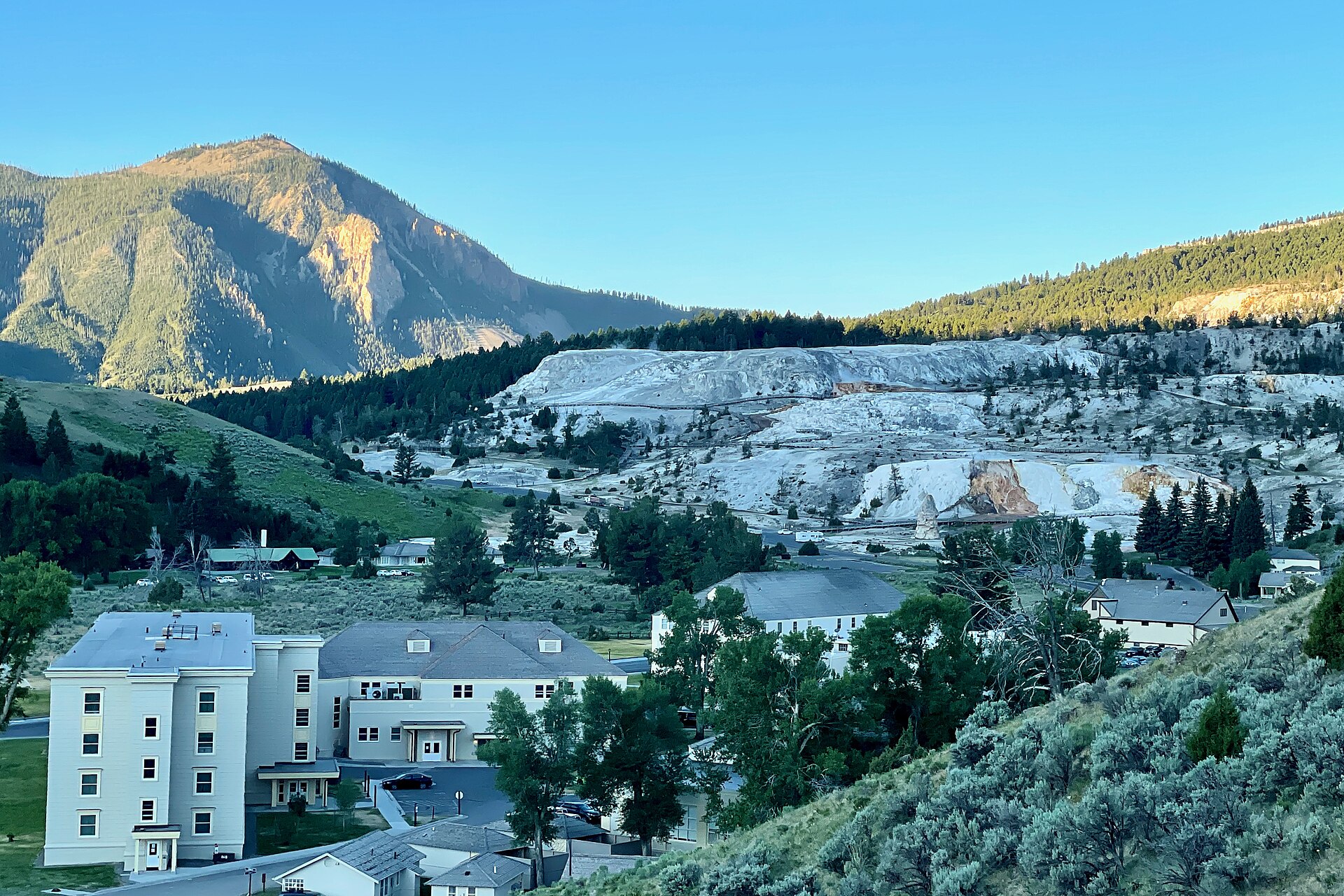 Area view of the Mammoth Hot Springs at dawn from the Beaver Ponds Trail in Mammoth, Wyoming. Vista of the Mammoth Hot Springs Hotel and the Mammoth Hot Springs Historic District.